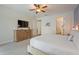 Bedroom with plush carpet, white walls, ceiling fan and a view of the ensuite bathroom at 7647 Fairfax Dr, Kissimmee, FL 34747