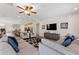 This living room features hardwood floors, neutral colored walls, a ceiling fan and an open floor plan at 7647 Fairfax Dr, Kissimmee, FL 34747