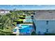 Aerial view of a private pool and patio with lounge chairs and tropical landscaping at 7647 Fairfax Dr, Kissimmee, FL 34747