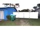 Backyard view showing a white fence and green trash cans at 1347 W Wellington Dr, Deltona, FL 32725