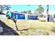 Backyard view of a blue house with a shed at 1347 W Wellington Dr, Deltona, FL 32725