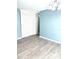 Dining room with light blue accent wall and wood-look floors at 1347 W Wellington Dr, Deltona, FL 32725