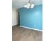 Dining room with light blue accent wall and wood-look floors at 1347 W Wellington Dr, Deltona, FL 32725