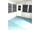 Screened Florida room with white door and light blue floor at 1347 W Wellington Dr, Deltona, FL 32725