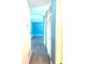 Clean hallway with light blue walls and wood-look floors at 1347 W Wellington Dr, Deltona, FL 32725