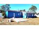 Rear view of a blue house with a screened patio at 1347 W Wellington Dr, Deltona, FL 32725