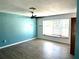 Bright living room with wood-look floors, bay window, and ceiling fan at 1347 W Wellington Dr, Deltona, FL 32725