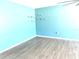 Living room with light blue walls, wood-look flooring, and ceiling fan at 1347 W Wellington Dr, Deltona, FL 32725