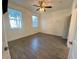 Sunlit bedroom offering neutral walls, wood-look flooring and a ceiling fan at 3468 Soho St # 107, Orlando, FL 32835
