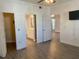 Spacious bedroom featuring gray flooring and entry to the bathroom and walk-in closet at 3468 Soho St # 107, Orlando, FL 32835