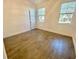 Sunny bedroom with neutral walls, wood-look floors, and bright double windows at 3468 Soho St # 107, Orlando, FL 32835