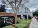 Exterior view of neighborhood grill featuring lush landscaping and sidewalk access at 3468 Soho St # 107, Orlando, FL 32835