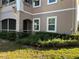 Well-maintained exterior with lush landscaping, trimmed bushes, and green grass at 3468 Soho St # 107, Orlando, FL 32835