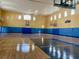 Bright gymnasium features two basketball hoops and a scoreboard at 3468 Soho St # 107, Orlando, FL 32835