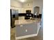 Modern kitchen with white cabinets, granite countertops, stainless steel appliances, and black backsplash at 3468 Soho St # 107, Orlando, FL 32835