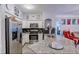 Modern kitchen with stainless steel appliances, a granite countertop, and a black backsplash at 3468 Soho St # 107, Orlando, FL 32835