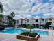 Community pool with lounge chairs, palm trees, and well-maintained landscaping at 3468 Soho St # 107, Orlando, FL 32835