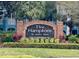 Community sign for The Hamptons at Metro West featuring manicured landscaping at 3468 Soho St # 107, Orlando, FL 32835