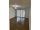 Bright living room with wood-look floors and sliding glass doors at 6008 Village Cir # Ge, Orlando, FL 32822