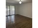 Spacious living room featuring wood-look floors and sliding glass doors at 6008 Village Cir # Ge, Orlando, FL 32822