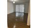 Bright living room with wood-look floors and access to a balcony at 6008 Village Cir # Ge, Orlando, FL 32822