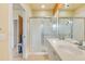 Bathroom with shower, double vanity, and view of hallway at 8547 Leatherleaf Ln, Orlando, FL 32827