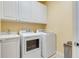 Laundry room with washer, dryer and cabinets at 8547 Leatherleaf Ln, Orlando, FL 32827