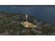 Aerial view of a home located near a lake, surrounded by trees, and neighboring houses at 1407 Edgewater Beach Dr, Lakeland, FL 33805