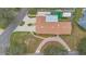 Aerial view of the property shows its long driveway, fenced yard, and the unique roof line at 1407 Edgewater Beach Dr, Lakeland, FL 33805