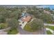 Aerial view of a home surrounded by trees, showcasing its location near a body of water at 1407 Edgewater Beach Dr, Lakeland, FL 33805