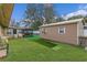 Backyard with a shed, patio and green turf, offering space for storage, leisure, and outdoor enjoyment at 1407 Edgewater Beach Dr, Lakeland, FL 33805