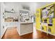 Bright eat-in kitchen with white cabinets, a kitchen island, and hardwood floors at 1407 Edgewater Beach Dr, Lakeland, FL 33805