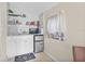 Efficient kitchenette features a mini-fridge, microwave, white cabinets, and practical shelving at 1407 Edgewater Beach Dr, Lakeland, FL 33805
