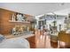 An open-concept living room with a brick fireplace, wood floors, and lots of natural light at 1407 Edgewater Beach Dr, Lakeland, FL 33805