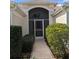 Screened-in front porch entry with paved walkway and lush landscaping at 1652 Homer Ave, The Villages, FL 32162