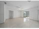 Bright living room with tile floors and sliding glass doors at 357 Lariat Ln, Kissimmee, FL 34743