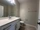 Bathroom featuring quartz counters, gray walls, and wood-look tile flooring at 1344 Lumpini St, Saint Cloud, FL 34771