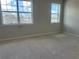 Bright bedroom with two large windows and neutral gray walls at 1344 Lumpini St, Saint Cloud, FL 34771
