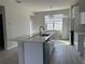 Spacious kitchen with a central island and stainless steel appliances, offering ample counter space at 1344 Lumpini St, Saint Cloud, FL 34771