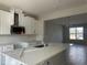 Modern kitchen featuring white cabinets, stainless steel appliances, and a quartz island at 1344 Lumpini St, Saint Cloud, FL 34771
