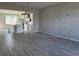 Open-concept living room with wood-look tile floors and neutral wall color at 1344 Lumpini St, Saint Cloud, FL 34771