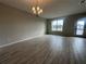 Bright living room with tile flooring, a chandelier, and a large window for natural light at 1344 Lumpini St, Saint Cloud, FL 34771
