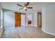 Primary bedroom with barn door, bathroom access, and ceiling fan at 171 Pheasant Dr, Haines City, FL 33844
