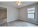 Spacious bedroom with wood-look floors and large window at 171 Pheasant Dr, Haines City, FL 33844