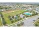 Aerial view showing community pool, playground, and open green space at 171 Pheasant Dr, Haines City, FL 33844