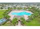Aerial view of community pool with surrounding lounge chairs and landscaping at 171 Pheasant Dr, Haines City, FL 33844