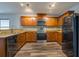 Modern kitchen with wood cabinets, granite countertops, and stainless steel appliances at 171 Pheasant Dr, Haines City, FL 33844