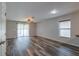 Spacious living room with wood-look floors and sliding glass doors at 171 Pheasant Dr, Haines City, FL 33844