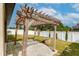 Wooden pergola with stone patio and fire pit area at 171 Pheasant Dr, Haines City, FL 33844