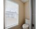Bathroom with a toilet next to a window with white blinds at 2142 Brandywine Falls Way, Orlando, FL 32824